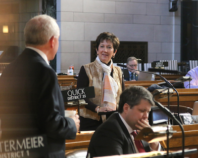Sen. Danielle Conrad asks Sen. LeRoy Louden a question on the floor of the Norris Chamber
